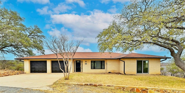 single story home with a garage and a front lawn