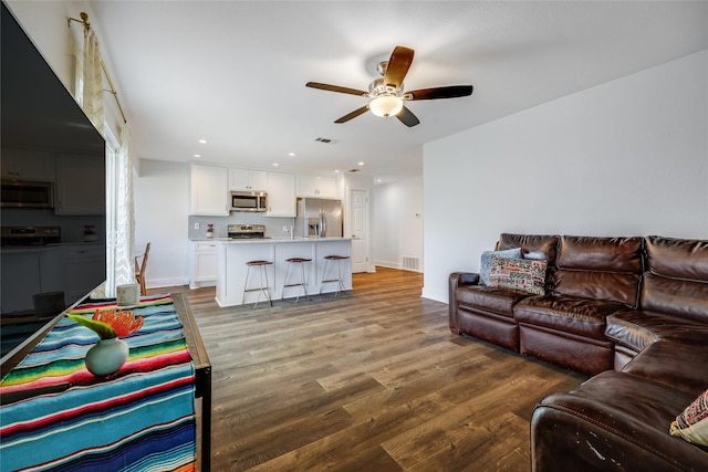 living room with light hardwood / wood-style floors and ceiling fan