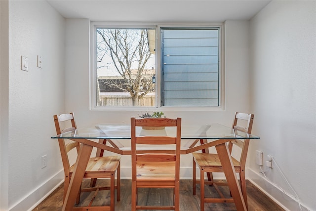 dining area featuring dark hardwood / wood-style flooring and a healthy amount of sunlight