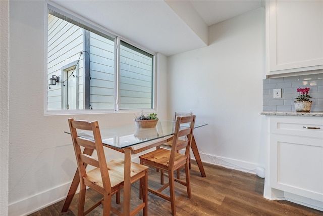 dining area with dark hardwood / wood-style floors