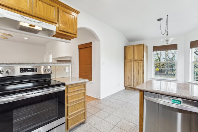 kitchen featuring decorative backsplash, hanging light fixtures, light tile patterned floors, light stone counters, and stainless steel appliances