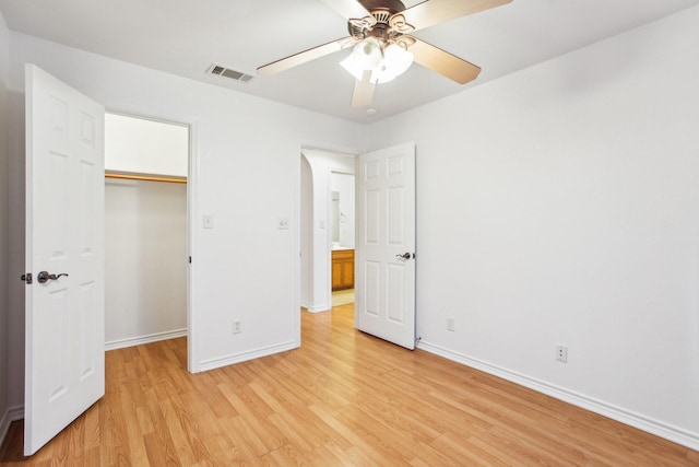 unfurnished bedroom with ceiling fan, a closet, and light hardwood / wood-style flooring