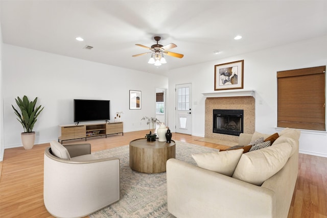 living room featuring ceiling fan and light wood-type flooring