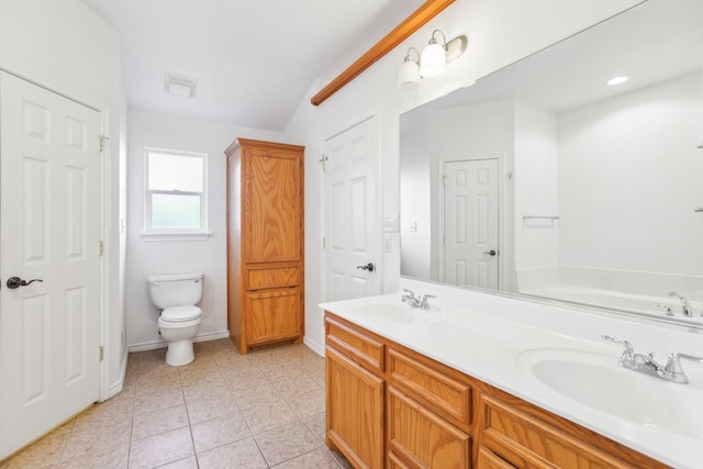 bathroom featuring vaulted ceiling, a tub, tile patterned flooring, vanity, and toilet