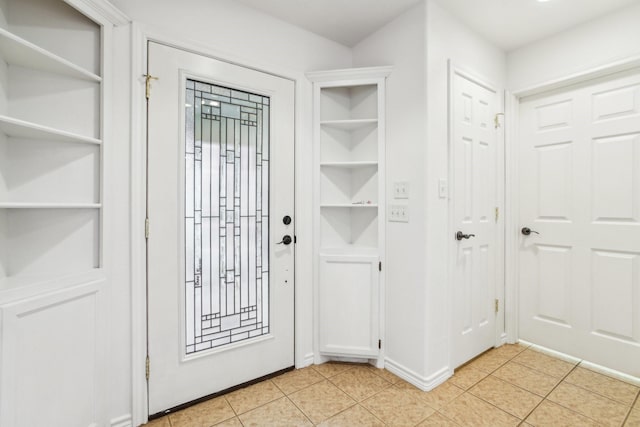 doorway to outside with light tile patterned floors