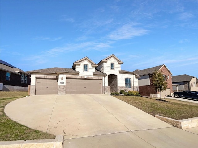 2120 Prairie Oaks Dr, Georgetown, TX 78628 - french country inspired facade featuring a garage, driveway, stone siding, and a front yard