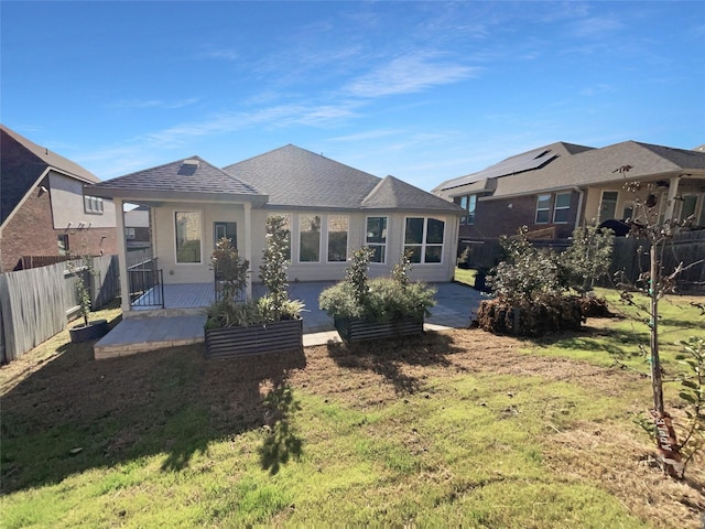 back of house with a patio and a yard