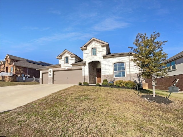 2120 Prairie Oaks Dr, Georgetown, TX 78628 - french country home featuring stone siding, a front lawn, concrete driveway, and an attached garage