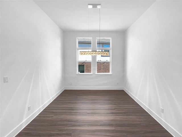 unfurnished dining area featuring dark hardwood / wood-style floors