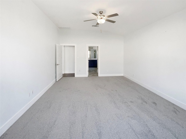 carpeted empty room with ceiling fan and vaulted ceiling