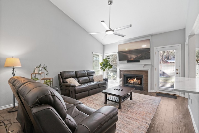 living room with lofted ceiling, dark wood-type flooring, and ceiling fan