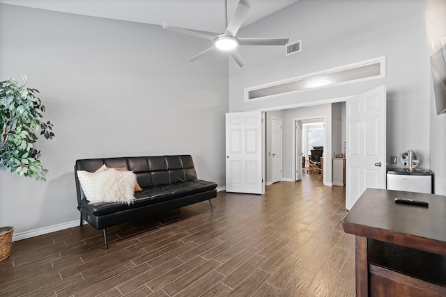 living area with ceiling fan and high vaulted ceiling