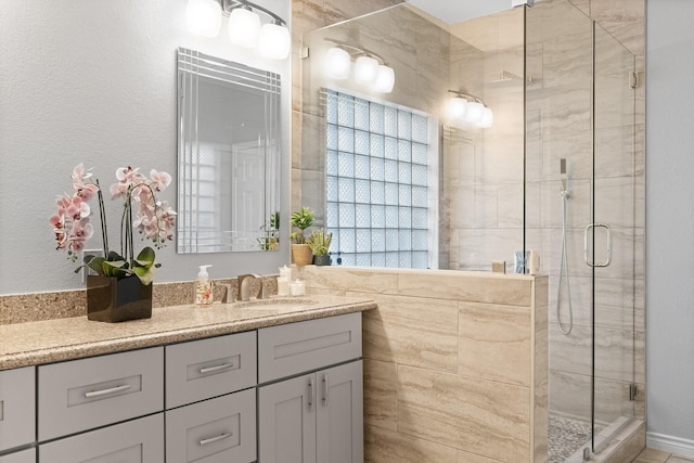 bathroom with vanity and a shower with door