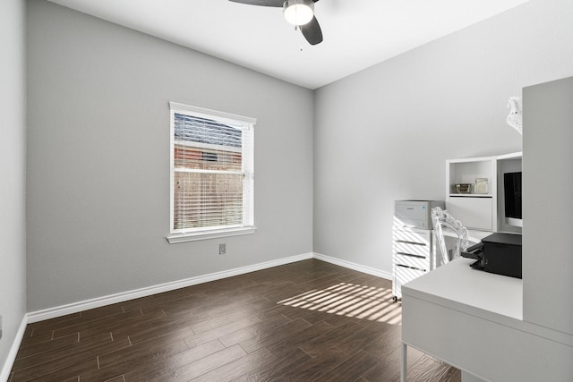 unfurnished office featuring dark hardwood / wood-style flooring and ceiling fan