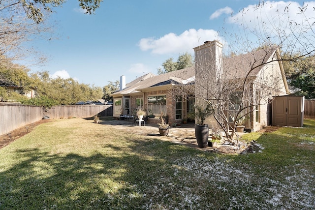 back of house with a yard, a shed, and a patio area