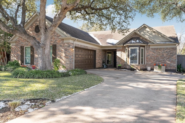 view of front of property with a garage and a front lawn