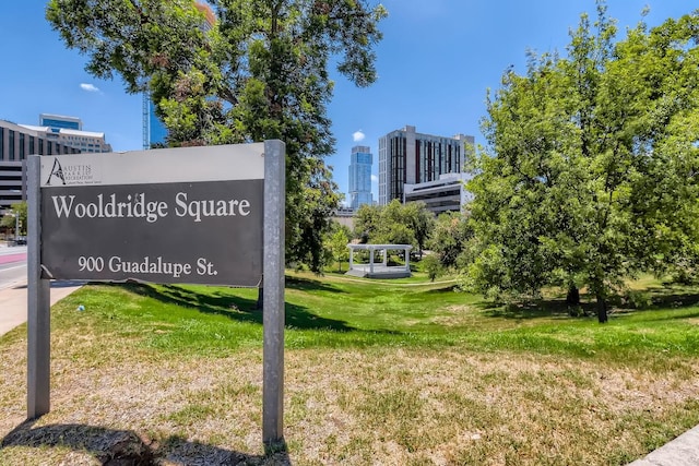 community sign featuring a lawn