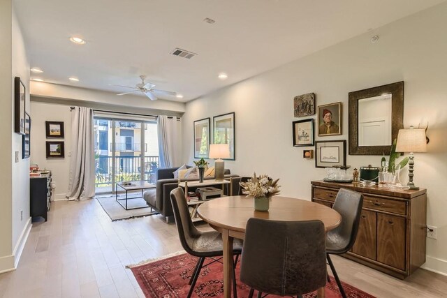 dining space featuring ceiling fan and light wood-type flooring