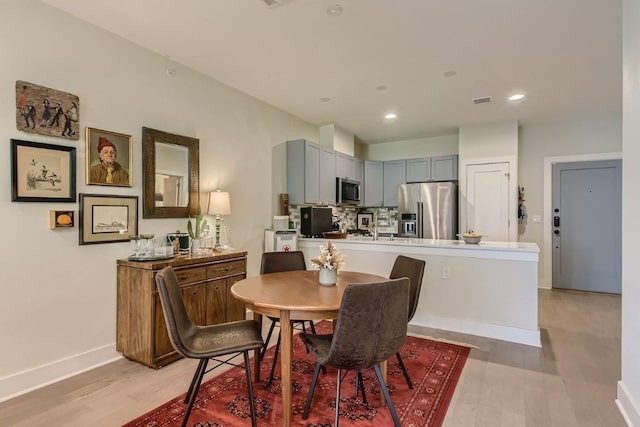 908 Nueces St Unit 37, Austin, TX 78701 - dining space with light wood finished floors and recessed lighting