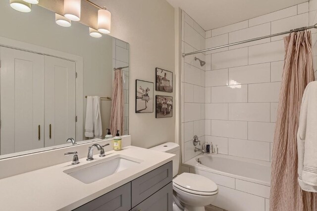 full bathroom with shower / tub combo, vanity, and toilet