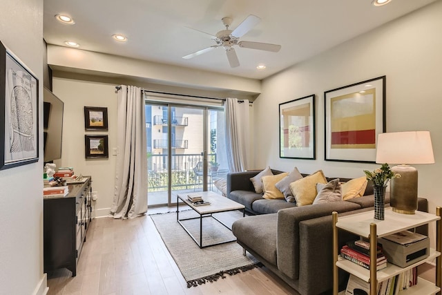 living room with ceiling fan and light wood-type flooring