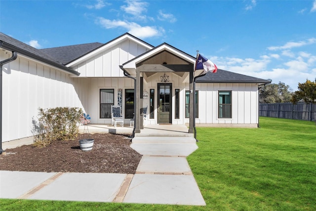 modern farmhouse style home with a porch and a front yard