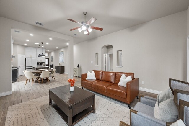 living room with sink and ceiling fan