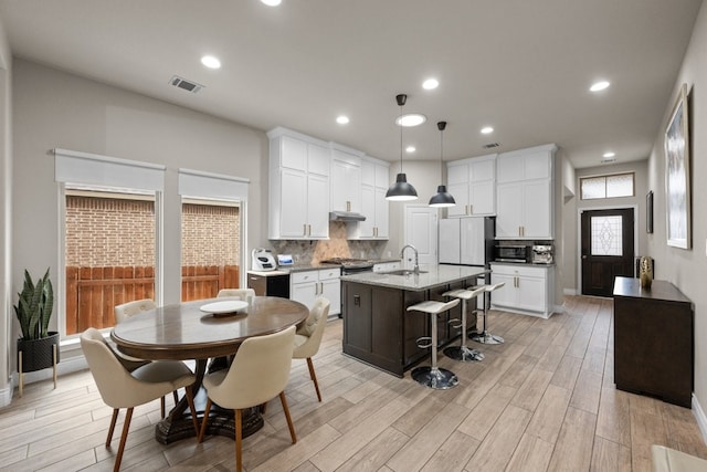 dining room featuring sink and light hardwood / wood-style flooring