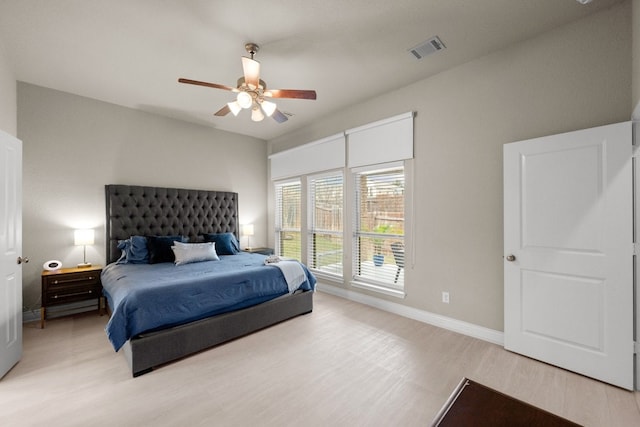 bedroom with ceiling fan and light hardwood / wood-style flooring