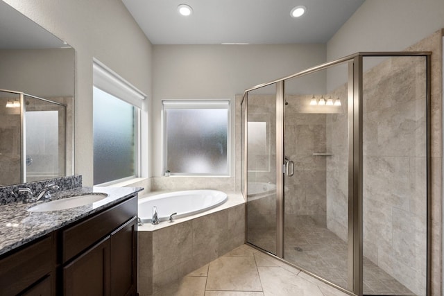 bathroom featuring independent shower and bath, vanity, and tile patterned floors