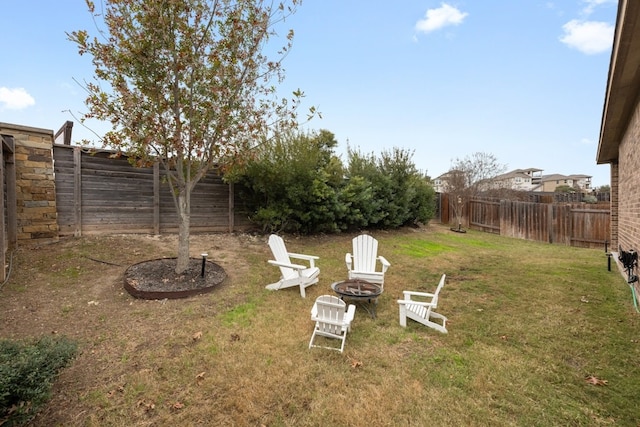 view of yard with a fire pit