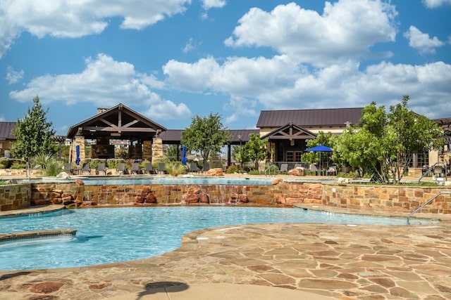 view of pool featuring a patio and pool water feature