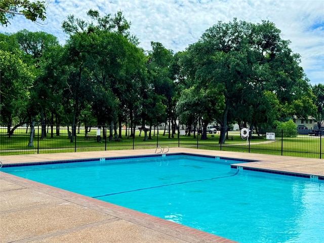 view of pool with a yard