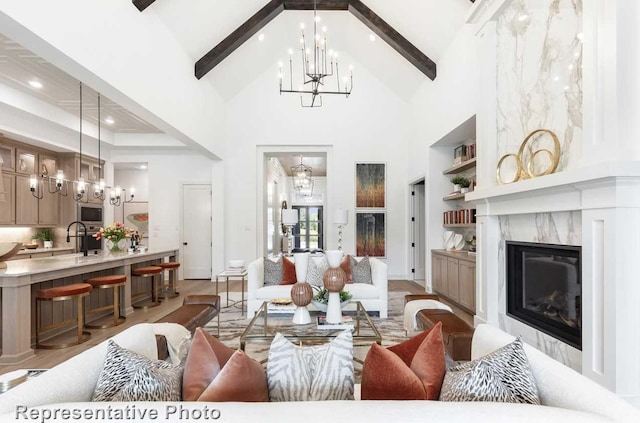 1304 Jolie Rose Bnd, Leander, TX 78641 - living room featuring beam ceiling, a notable chandelier, high vaulted ceiling, and a fireplace