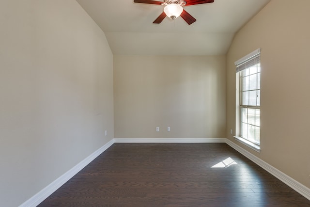 empty room with vaulted ceiling, dark hardwood / wood-style floors, and ceiling fan