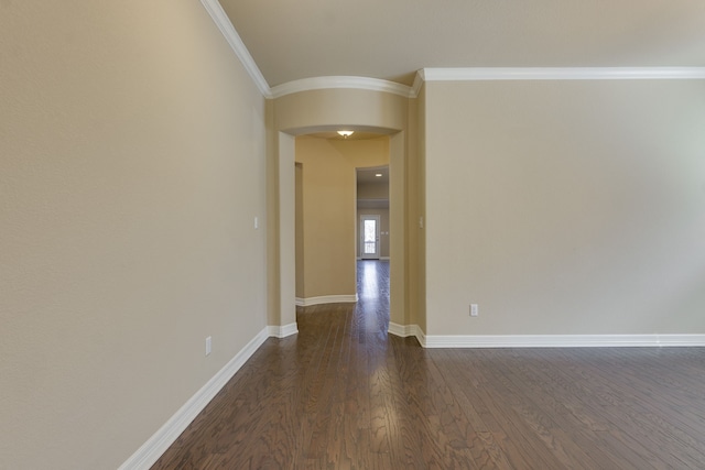 spare room featuring crown molding and dark hardwood / wood-style floors