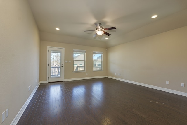 spare room with dark wood-type flooring and ceiling fan