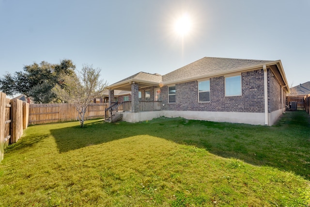 back of property featuring a lawn