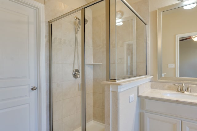 bathroom with vanity and a shower with door