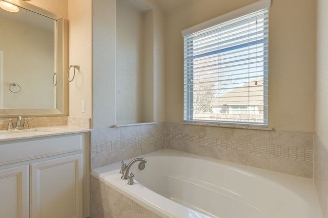 bathroom with vanity and a relaxing tiled tub