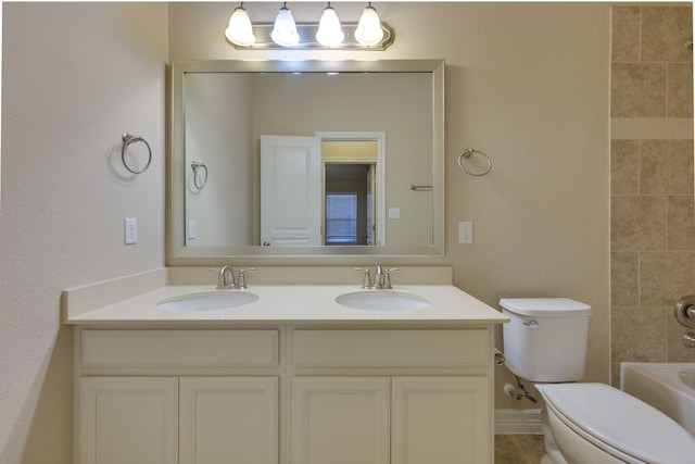 full bathroom with vanity, toilet, and tiled shower / bath combo