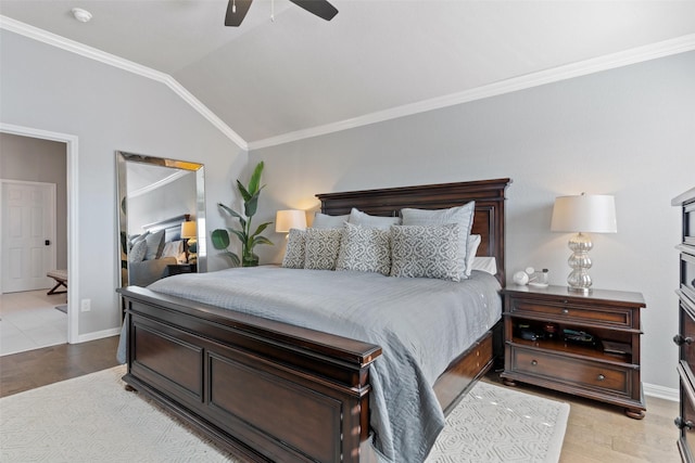 bedroom with light hardwood / wood-style flooring, vaulted ceiling, ornamental molding, and ceiling fan