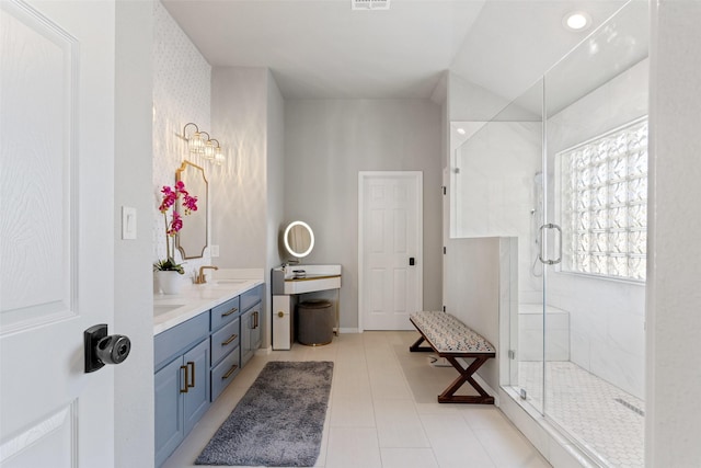 bathroom with tile patterned flooring, vanity, and a shower with shower door