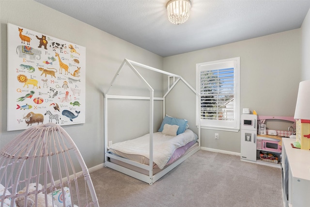 carpeted bedroom featuring a textured ceiling