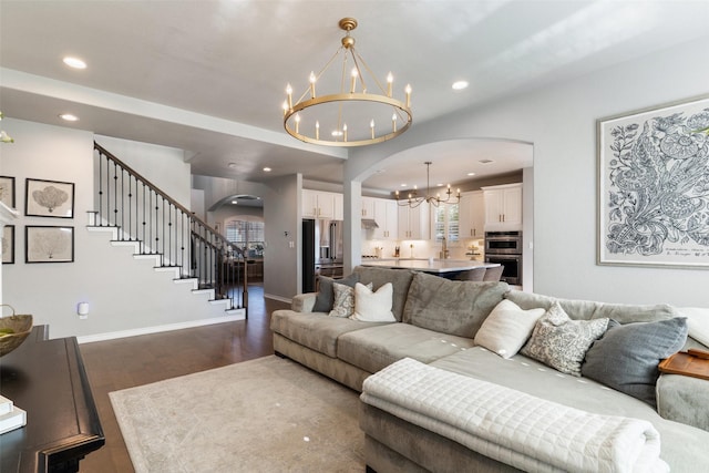 living room with wood-type flooring and an inviting chandelier