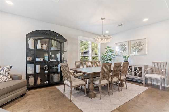 dining room featuring light hardwood / wood-style flooring and a chandelier