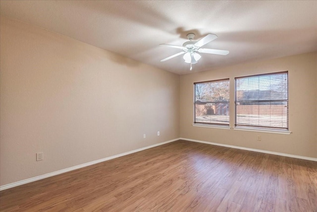 unfurnished room with ceiling fan and hardwood / wood-style floors