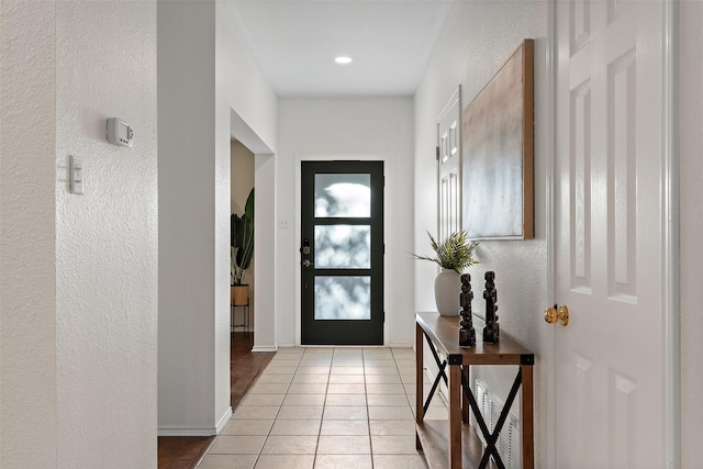 doorway featuring light tile patterned flooring