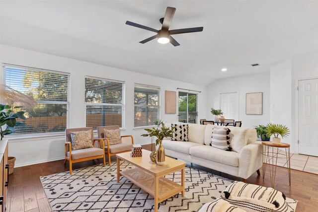 living room featuring vaulted ceiling, ceiling fan, and light hardwood / wood-style floors