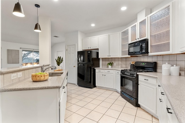 kitchen featuring tasteful backsplash, sink, white cabinets, hanging light fixtures, and black appliances